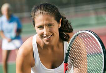 Woman playing tennis after acupunture