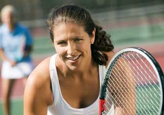 Woman playing tennis after acupunture